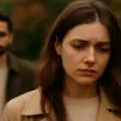Jeune femme au regard triste, de dos à un homme distant dans un parc d’automne, illustrant l’amour non réciproque et les relations déséquilibrées.